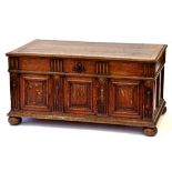 AN OAK CHEST WITH MOULDED LID, THE FRONT WITH THREE RAISED AND FIELDED PANELS AND MOULDED