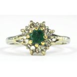 AN EMERALD AND DIAMOND CLUSTER RING, IN WHITE GOLD, INDISTINCTLY MARKED, 2.3G GROSS