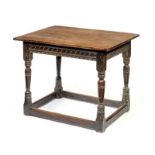 A WILLIAM III OAK SIDE TABLE, C1700 branded IT, the boarded top with cleated ends above carved