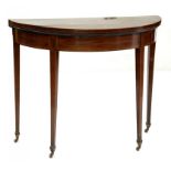 A GEORGE III MAHOGANY CARD TABLE CROSSBANDED IN ROSEWOOD AND LINE INLAID ON BRASS CASTORS, 73CM H