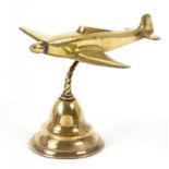 A 1930'S CAST BRASS MODEL OF AN AEROPLANE, ON LEAD WEIGHTED BRASS FOOT, 14CM H