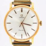 AN OMEGA 18CT GOLD GENTLEMAN'S WRISTWATCH, ON A PLATED BRACELET, WITH PAPERS