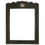 AN INDIAN CARVED AND BLACK PAINTED WOOD PICTURE FRAME INSET WITH A MINIATURE, 79CM H