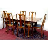 A WALNUT EXTENDING DINING TABLE, 180CM L AND A SET OF 6 DINING CHAIRS WITH CLAW AND BALL FEET