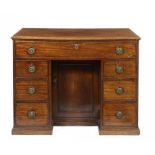 A GEORGE III MAHOGANY KNEEHOLE DRESSING TABLE, C1820 the top drawer with leather inlet slide and