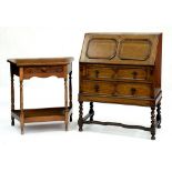 AN OAK BUREAU ON SPIRAL TURNED LEGS AND A CARVED OAK SIDE TABLE