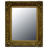 A VICTORIAN GILTWOOD AND COMPOSITION PICTURE FRAME, REUSED AS A MIRROR, 69CM X 58CM OVERALL