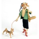 AN UNUSUAL 1930'S FELT DOLL OR FIGURE OF A LADY WITH A LORGNETTE AND DOG, 24CM H