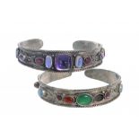 TWO ARTS & CRAFTS JEWELLED SILVER BANGLES, C1920 applied with wirework and set with amethysts,