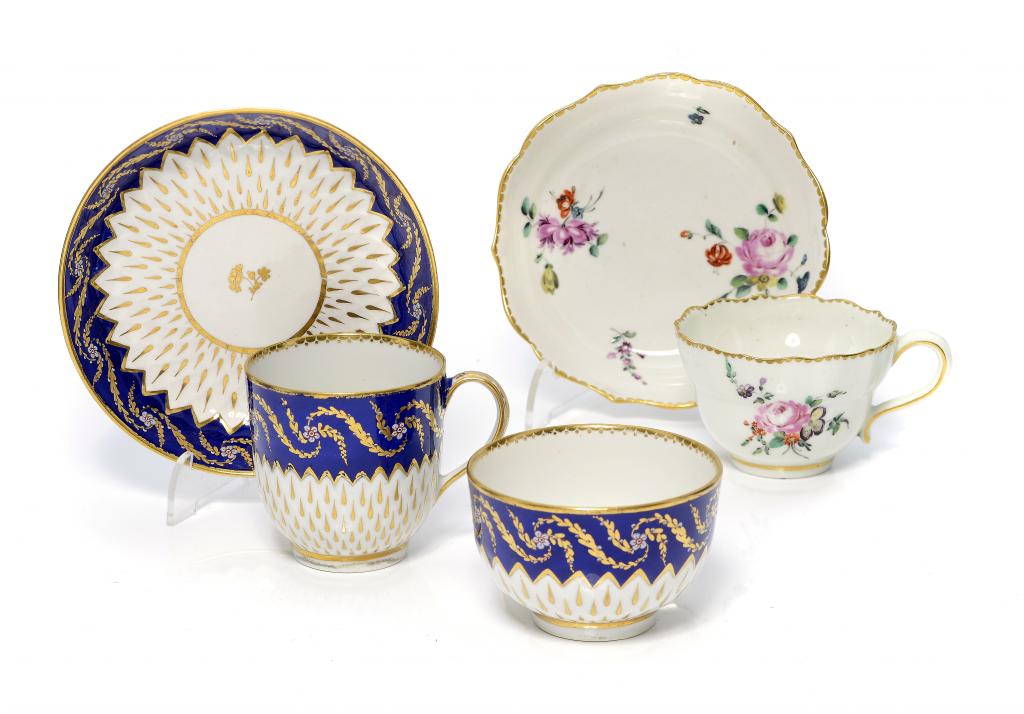 A DERBY OGEE TEACUP AND SAUCER AND A BLUE AND GILT TRIO, C1775 & C1785-90 saucers 12 & 12.5cm