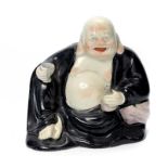 A STAFFORDSHIRE PEARLWARE FIGURE OF HOTEI, C1820 holding a bottle and glass and clad in a black