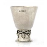 AN OMAR RAMSDEN SILVER BEAKER the cylindrical foot applied with water leaves, 10.5cm h, maker's