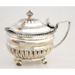 A GEORGE III SILVER LOBED OBLONG MUSTARD POT WITH DOMED LID AND GADROONED RIM, CRESTED, BLUE GLASS