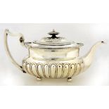 A GEORGE III SILVER LOBED OBLONG TEAPOT WITH GADROONED RIM WITH SHELLS AT THE ANGLES, THE DOMED