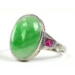 A JADEITE RING, THE CABOCHON FLANKED BY RUBY AND DIAMOND SET SHOULDERS, IN PLATINUM, INDISTINCTLY