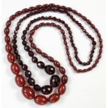 TWO NECKLACES OF CHERRY AMBER BEADS, ONE FACETED, 127G