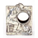 AN UNUSUAL EDWARD VII SILVER STRUT CLOCK FRAME, THE MOUNT EMBOSSED WITH A SLEEPING MAN AND HIS