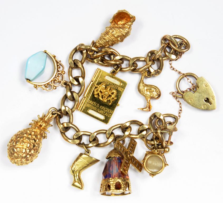 A GOLD CHARM BRACELET, 60.4G GROSS