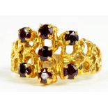 A GARNET SET 9CT GOLD OPENWORK RING, 4.9G GROSS