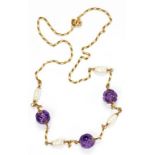 A GOLD NECKLET WITH CARVED AMETHYST BEADS ALTERNATING WITH BAROQUE PEARLS AT INTERVALS, MARKED