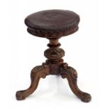A VICTORIAN CARVED WALNUT PIANO STOOL