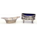 A GEORGE V PIERCED SILVER NAVETTE SHAPED SALT CELLAR, BLUE GLASS LINER, 8.5CM W, CHESTER 1911 AND