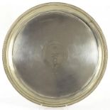 A VICTORIAN EPNS SALVER, ENGRAVED WITH CREST AND MONOGRAM, BEADED RIM, 46CM DIAM