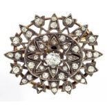 A DIAMOND BROOCH-PENDANT WITH A LARGER CENTRAL CUSHION SHAPED OLD CUT DIAMOND, IN GOLD, LATE 19TH