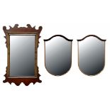 A PAIR OF MAHOGANY SHIELD SHAPED MIRRORS, 47CM H AND A WALNUT FRETTED FRAME MIRROR, BOTH EARLY