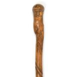A CARVED BRIARWOOD WALKING CANE, THE HANDLE IN THE FORM OF THE HEAD OF A MAN WITH A MOUSTACHE, 76.
