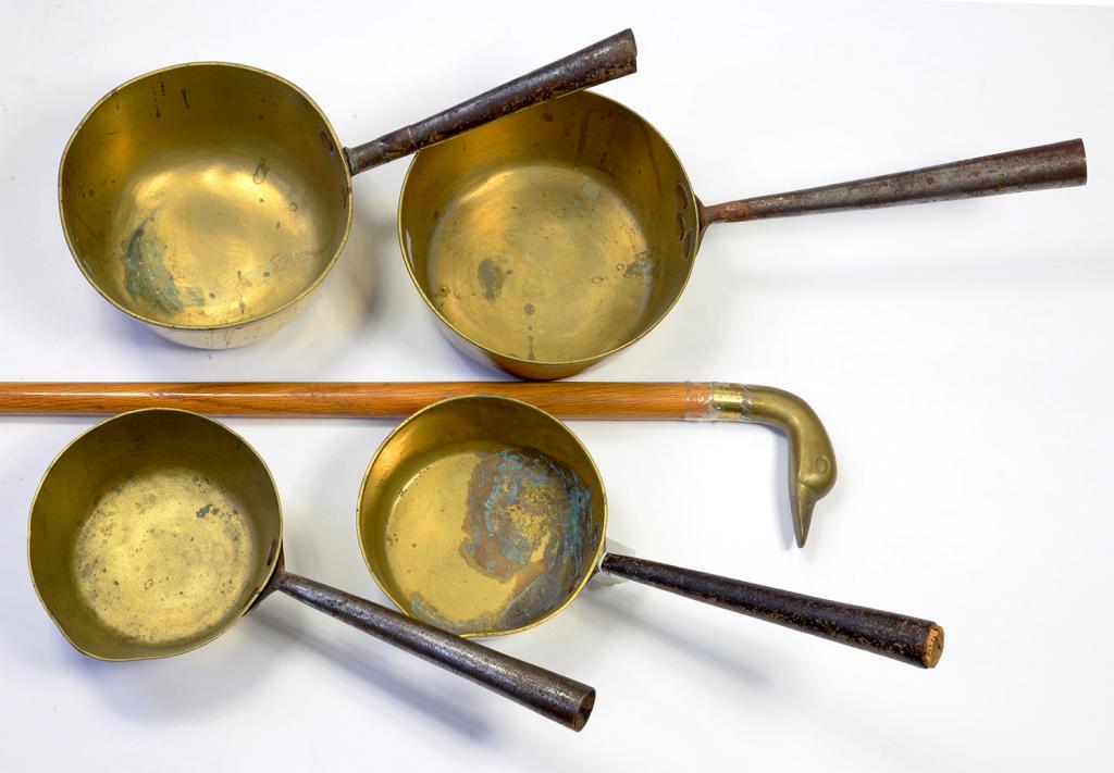 THREE VICTORIAN BRASS SAUCEPANS AND A BRASS HANDLED WALKING CANE