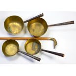 THREE VICTORIAN BRASS SAUCEPANS AND A BRASS HANDLED WALKING CANE