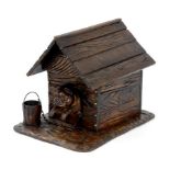 A SWISS CARVED AND DARK STAINED LIMEWOOD CIGAR BOX IN THE FORM OF A DOG IN A KENNEL, 24.5CM W,