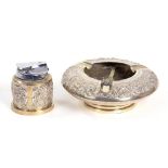 A SOUTH EAST ASIAN SILVER REPOUSSÉ FOOTED ASHTRAY, 15CM DIAM AND A SIMILAR SILVER SLEEVED TABLE