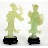 A PAIR OF CHINESE CARVED JADE FIGURES OF YOUNG WOMEN, 17CM H, ON TWO WOOD STANDS, BOXED, 20TH C