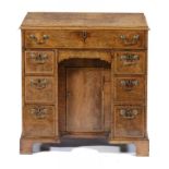 A GEORGE II WALNUT AND FEATHERBANDED KEYHOLE DRESSING TABLE, C1740 the hinged top revealing a fitted