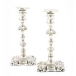 A PAIR OF GEORGE II SILVER CANDLESTICKS crested on foot and nozzle, 23cm h marked on sconce,