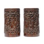 A PAIR OF CHINESE CARVED BAMBOO BRUSH POTS the principal scene flanked by inscriptions, the