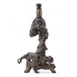 A CHINESE ROOTWOOD CARVING OF GUANYIN, 19TH/20TH C 59cm h ++Coated in a somewhat uneven varnish,