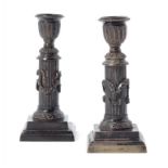A PAIR OF NEO CLASSICAL STYLE BRONZE DWARF CANDLESTICKS, 19TH C 15cm h ++Both in good condition with