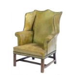 A GEORGE III MAHOGANY ARMCHAIR, LATE 18TH C with wing back, in close nailed green hide, 106cm h ++