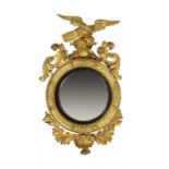 AN ENGLISH GILTWOOD CONVEX MIRROR, C1830 crested by an eagle on rocks, with Venus shell apron, 120cm