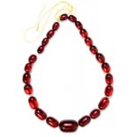 A NECKLACE OF CHERRY AMBER BEADS, 51G