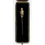 AN UNUSUAL FRENCH GOLD STICK PIN THE TERMINAL IN THE FORM OF A BABY, FULLY ARTICULATED, CONTROL