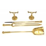 A SET OF THREE BRASS FIRE IRONS, TONGS, 68CM L AND A PAIR OF CONTEMPORARY BRASS IMPLEMENT RESTS,