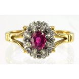 A RUBY AND DIAMOND CLUSTER RING IN GOLD MARKED 18CT, 4G