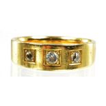 A DIAMOND THREE STONE GYPSY SET RING IN GOLD MARKED 18CT, 5.6G
