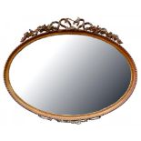 A GILTWOOD AND COMPOSITION OVAL MIRROR WITH BEVELLED PLATE, 65CM H, 80CM W