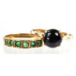 A GOLD RING SET WITH A BLACK ONYX CABOCHON MARKED 14K AND AN EMERALD RING IN GOLD MARKED 14K, 3.8G