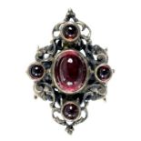 A MANNERIST STYLE CABOCHON GARNET SET SILVER RING PROBABLY AUSTRO-HUNGARIAN UNMARKED CIRCA 1900,